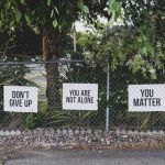 Mental Health - don't give up. You are not alone, you matter signage on metal fence