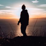 Self-discovery - silhouette of man standing on hill during sunset