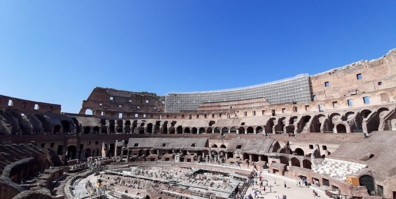 Colosseum Rome - the inside of an ancient building with a sky background