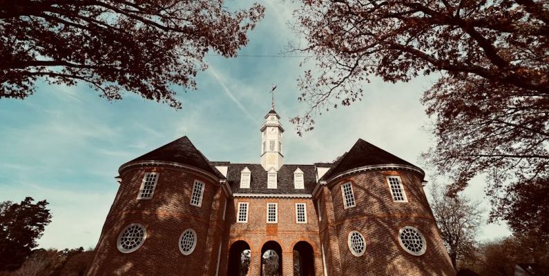 Colonial Williamsburg - a large brick building with a clock tower