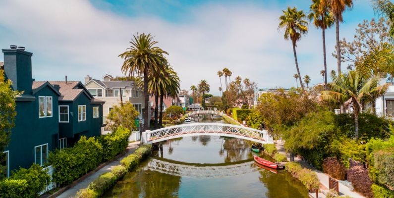 Venice Canals - selective focus photography of small bridge and body of water during daytime