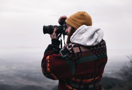 Travel Photography - person in gray hoodie using black binoculars