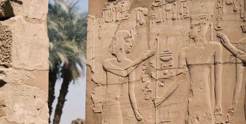 Egyptian Hieroglyphs - a stone wall with carvings