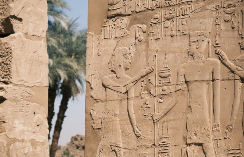 Egyptian Hieroglyphs - a stone wall with carvings