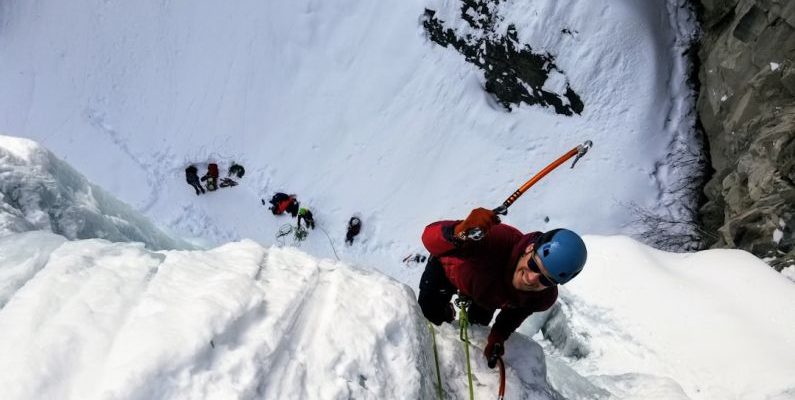 Ice Climbing - man wearing long-sleeved shirt climbing on mountain