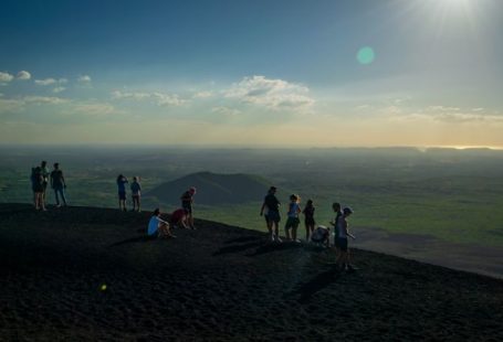 Volcano Boarding - people standing on top of cliff during daytime