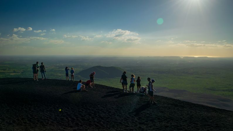 Volcano Boarding - people standing on top of cliff during daytime