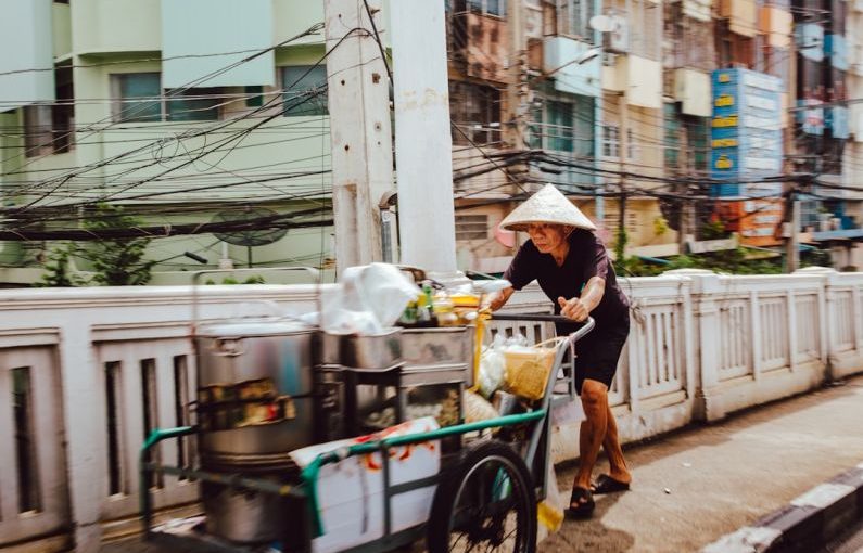 Thai Street Food - man pushing the cart on street